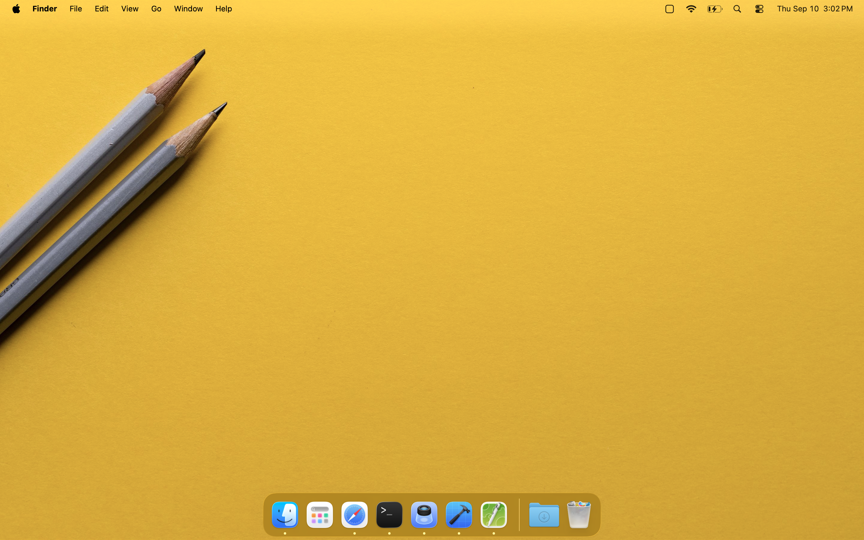 The same macOS desktop with every icon hidden by LilHide